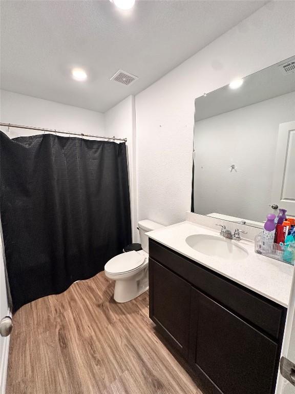 1214 Smallmouth Rd, Bastrop, TX 78602 - bathroom featuring wood finished floors, vanity, and curtained shower