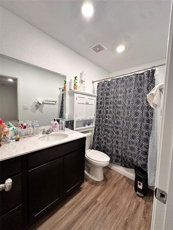 1214 Smallmouth Rd, Bastrop, TX 78602 - full bathroom featuring wood finished floors, vanity, and recessed lighting