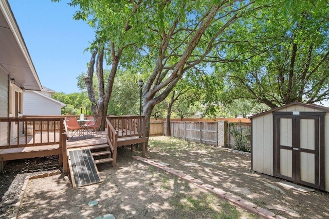 9273 Vigen Cir, Austin, TX 78748 - wooden deck with a storage unit, a fenced backyard, and outdoor dining space