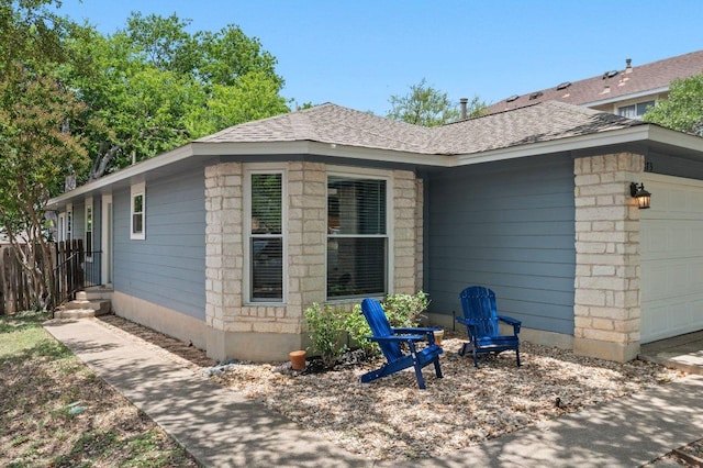 9273 Vigen Cir, Austin, TX 78748 - view of side of home featuring an attached garage and roof with shingles