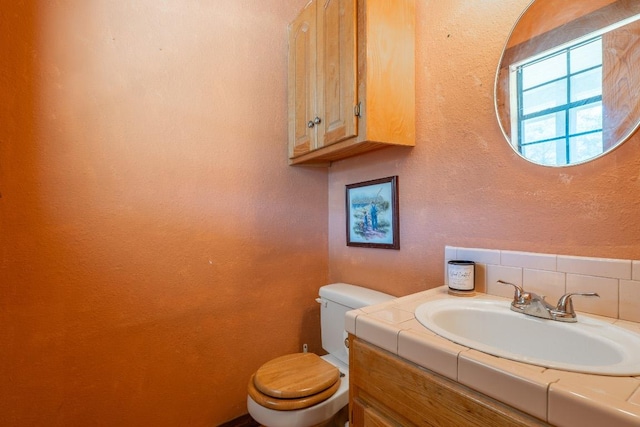 2700 County Road 224, Florence, TX 76527 - bathroom featuring vanity, backsplash, and a textured wall