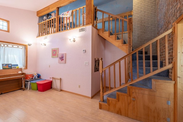 2700 County Road 224, Florence, TX 76527 - staircase featuring wood finished floors and a high ceiling