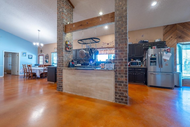2700 County Road 224, Florence, TX 76527 - kitchen with stainless steel appliances, finished concrete flooring, a chandelier, healthy amount of natural light, and high vaulted ceiling