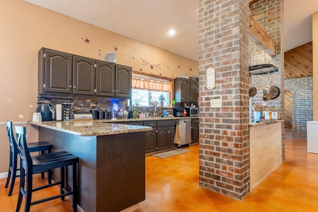 2700 County Road 224, Florence, TX 76527 - kitchen featuring finished concrete floors, a peninsula, decorative backsplash, a breakfast bar, and dishwasher