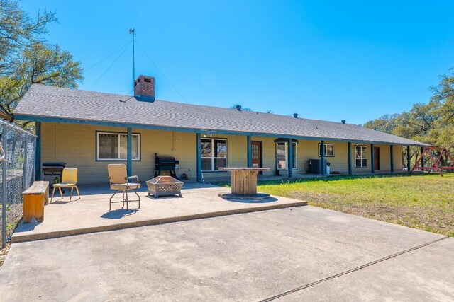 2700 County Road 224, Florence, TX 76527 - back of house with an outdoor fire pit, a chimney, a patio area, and a lawn