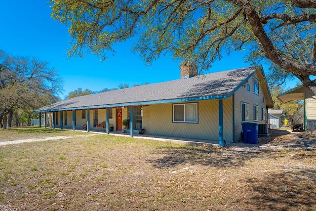 2700 County Road 224, Florence, TX 76527 - view of front of house featuring a chimney, a front lawn, and a patio area