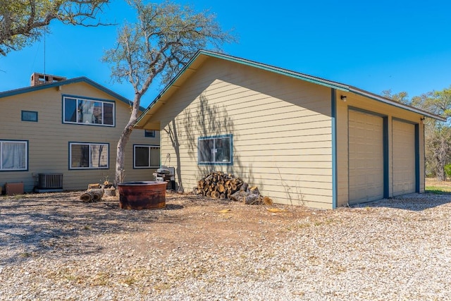 2700 County Road 224, Florence, TX 76527 - rear view of property with a detached garage