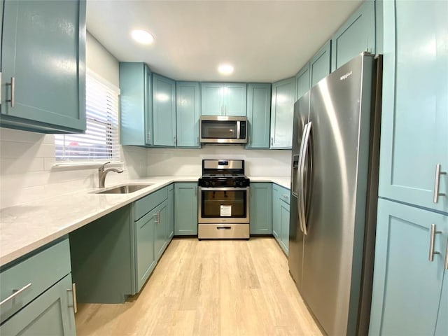 6920 Bethune Ave, Austin, TX 78752 - kitchen featuring stainless steel appliances, light wood-style floors, green cabinetry, and recessed lighting