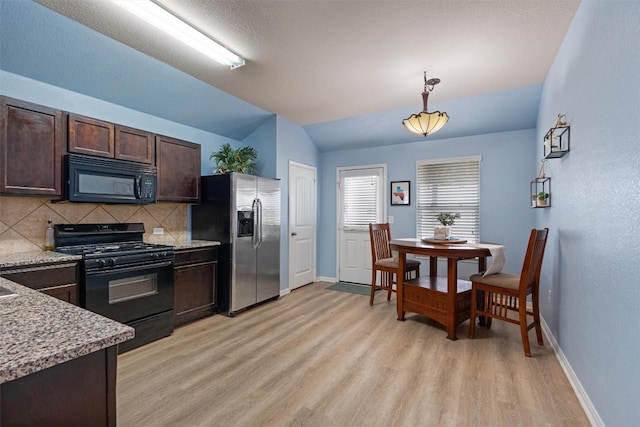 233 Voss, Kyle, TX 78640 - kitchen featuring black appliances, vaulted ceiling, dark brown cabinets, decorative backsplash, and light wood finished floors