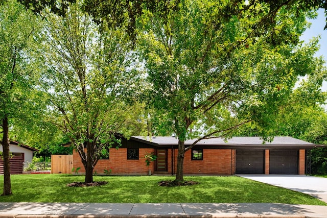 1405 Ridgehaven Dr, Austin, TX 78723 - view of front of property with driveway, an attached garage, and brick siding