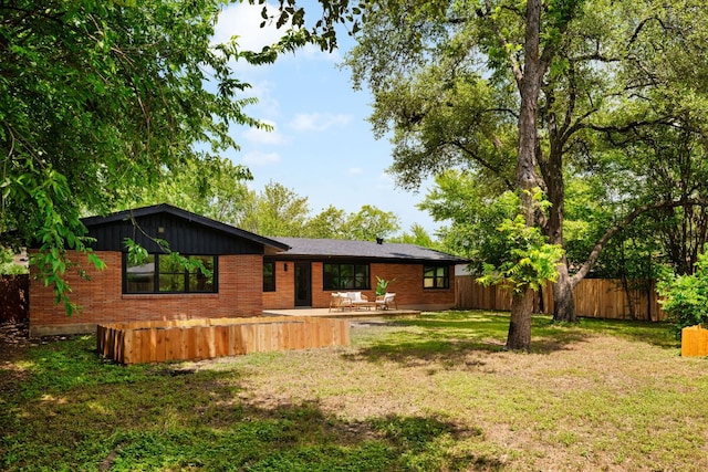 1405 Ridgehaven Dr, Austin, TX 78723 - back of property with brick siding and a patio area