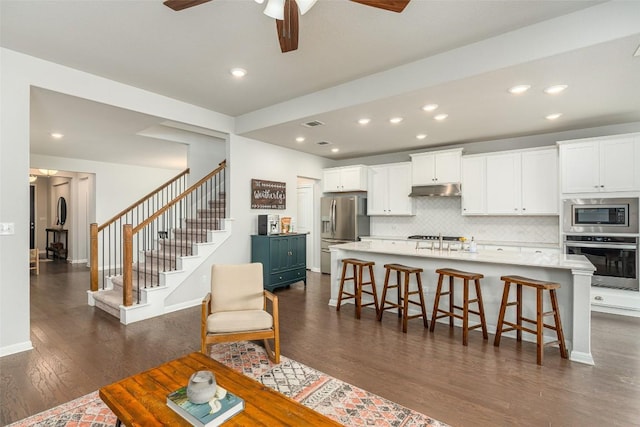 2049 Cartway Ct, Leander, TX 78641 - living room with dark wood-style flooring, a ceiling fan, stairway, and recessed lighting