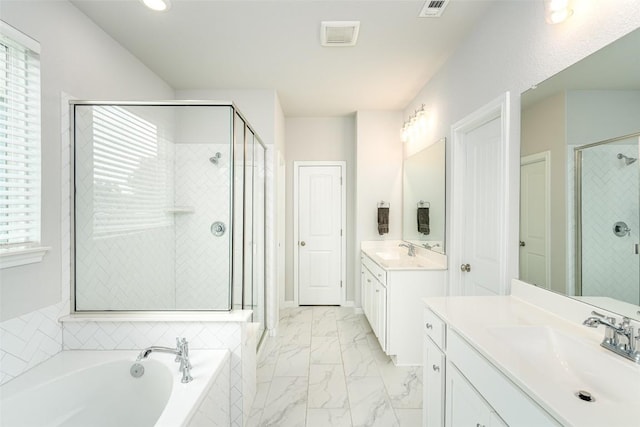 2049 Cartway Ct, Leander, TX 78641 - bathroom featuring a shower stall, two vanities, a bath, marble look tile flooring, and recessed lighting