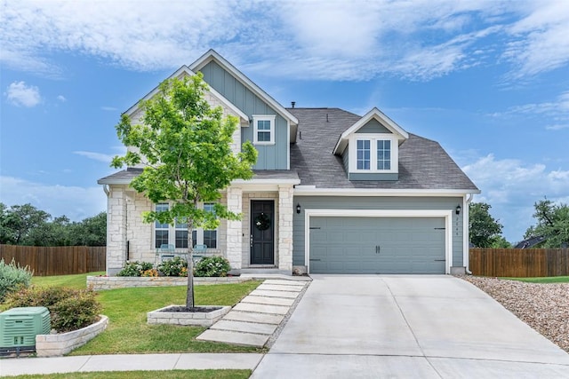 2049 Cartway Ct, Leander, TX 78641 - craftsman-style house with board and batten siding, concrete driveway, stone siding, and a garage