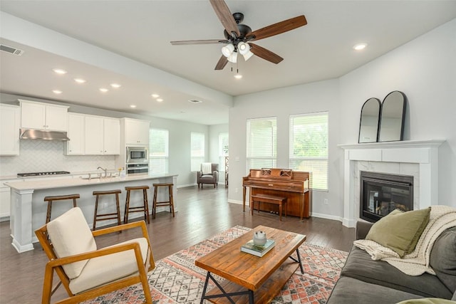 2049 Cartway Ct, Leander, TX 78641 - living room with recessed lighting, a ceiling fan, dark wood-style floors, and a fireplace