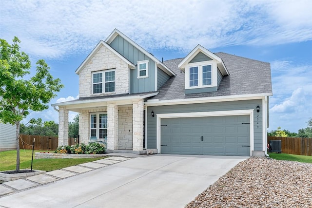 2049 Cartway Ct, Leander, TX 78641 - craftsman-style house with board and batten siding, driveway, stone siding, and a garage