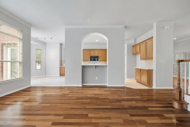 3213 Summer Canyon Dr, Austin, TX 78732 - unfurnished living room with light wood-style floors, arched walkways, and ornamental molding