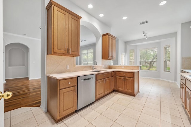3213 Summer Canyon Dr, Austin, TX 78732 - kitchen featuring dishwasher, arched walkways, light tile patterned floors, light countertops, and recessed lighting