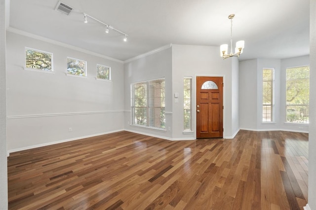 3213 Summer Canyon Dr, Austin, TX 78732 - entryway featuring track lighting, wood finished floors, a chandelier, plenty of natural light, and crown molding