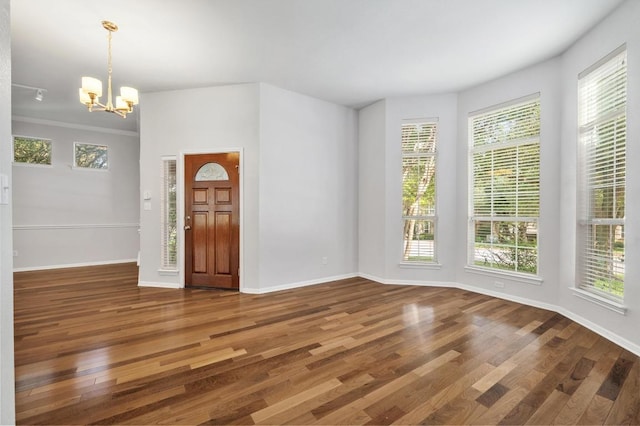 3213 Summer Canyon Dr, Austin, TX 78732 - foyer entrance featuring wood finished floors, a chandelier, and healthy amount of natural light