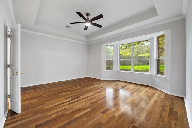 3213 Summer Canyon Dr, Austin, TX 78732 - unfurnished room with a raised ceiling, a ceiling fan, wood finished floors, and ornamental molding