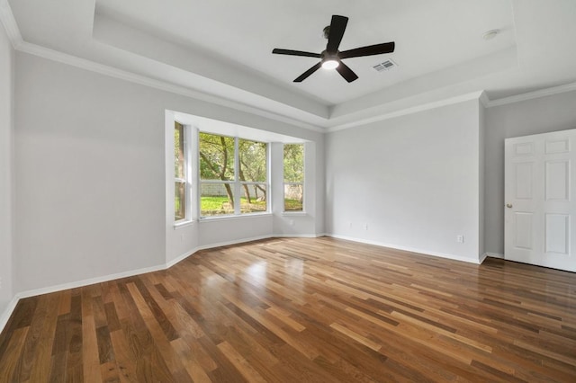 3213 Summer Canyon Dr, Austin, TX 78732 - empty room featuring a raised ceiling, wood finished floors, a ceiling fan, and ornamental molding