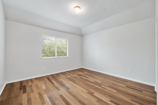 3213 Summer Canyon Dr, Austin, TX 78732 - spare room with wood finished floors and vaulted ceiling
