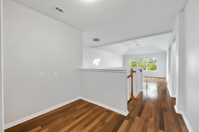 3213 Summer Canyon Dr, Austin, TX 78732 - hall featuring an upstairs landing, dark wood-style floors, vaulted ceiling, and track lighting