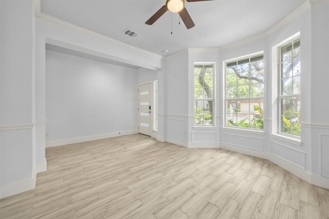 8104 Broken Branch Dr, Round Rock, TX 78681 - spare room with ornamental molding, a ceiling fan, light wood finished floors, a decorative wall, and a wainscoted wall