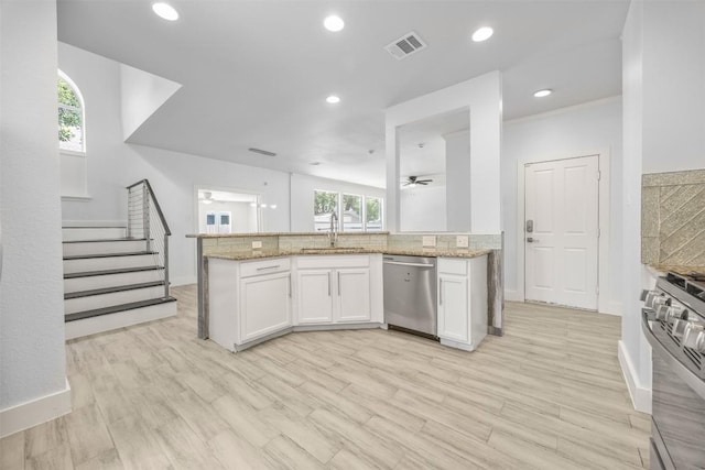 8104 Broken Branch Dr, Round Rock, TX 78681 - kitchen with stainless steel appliances, white cabinetry, light stone countertops, ceiling fan, and recessed lighting