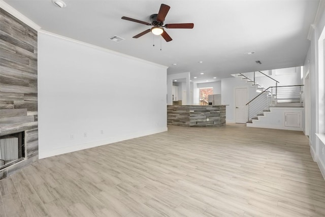 8104 Broken Branch Dr, Round Rock, TX 78681 - unfurnished living room with stairway, a large fireplace, a ceiling fan, ornamental molding, and recessed lighting