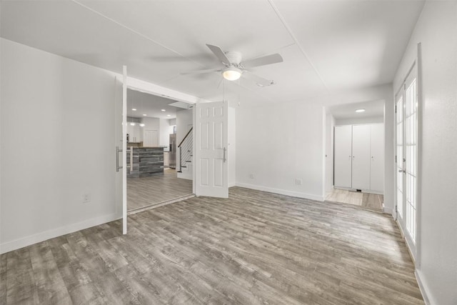 8104 Broken Branch Dr, Round Rock, TX 78681 - unfurnished living room featuring a ceiling fan, wood finished floors, and stairway