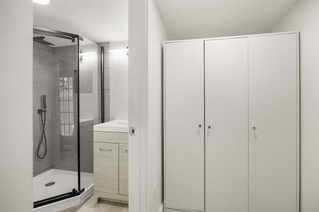 8104 Broken Branch Dr, Round Rock, TX 78681 - bathroom with a stall shower, vanity, a closet, and wood finished floors