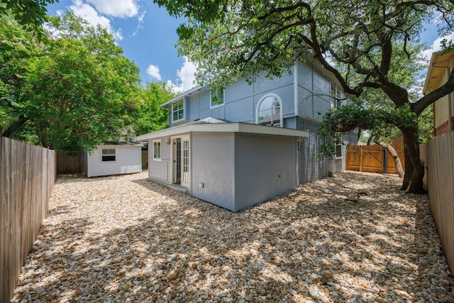 8104 Broken Branch Dr, Round Rock, TX 78681 - back of property featuring a fenced backyard, an outbuilding, and stucco siding