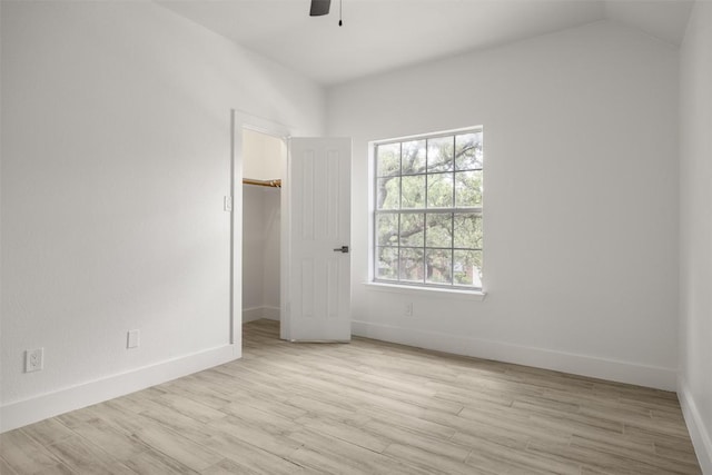 8104 Broken Branch Dr, Round Rock, TX 78681 - unfurnished bedroom with a spacious closet, wood finished floors, ceiling fan, and vaulted ceiling