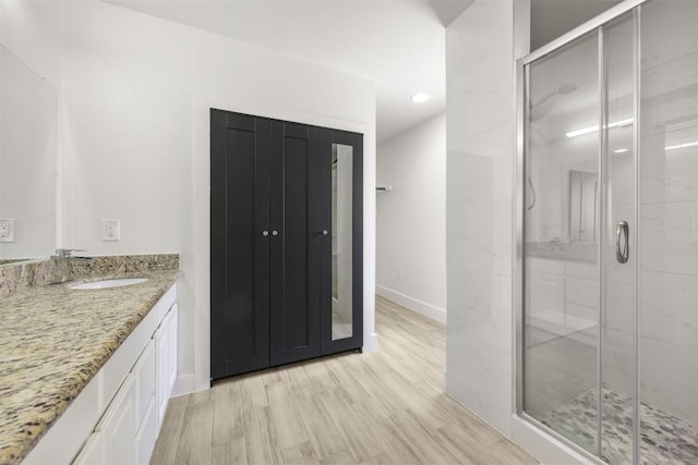8104 Broken Branch Dr, Round Rock, TX 78681 - full bathroom featuring vanity, a stall shower, wood finished floors, and recessed lighting