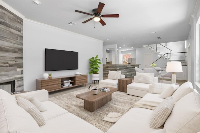 8104 Broken Branch Dr, Round Rock, TX 78681 - living area featuring stairway, a ceiling fan, a premium fireplace, recessed lighting, and crown molding