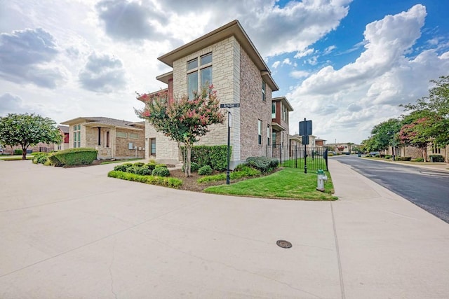 600 E Baylee Love Ln, Austin, TX 78717 - view of side of property featuring stone siding and a residential view