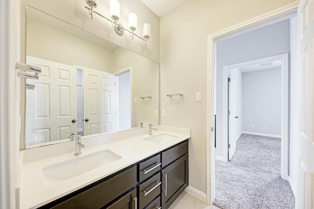 600 E Baylee Love Ln, Austin, TX 78717 - bathroom featuring double vanity and baseboards