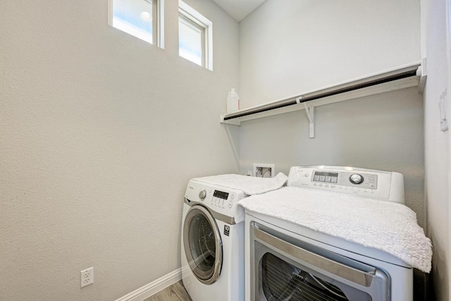 600 E Baylee Love Ln, Austin, TX 78717 - laundry room featuring washer and dryer and wood finished floors