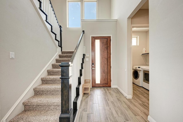 600 E Baylee Love Ln, Austin, TX 78717 - entrance foyer with washing machine and clothes dryer, wood finished floors, and stairs
