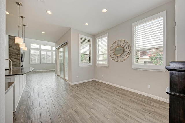600 E Baylee Love Ln, Austin, TX 78717 - unfurnished living room featuring light wood-style flooring and recessed lighting