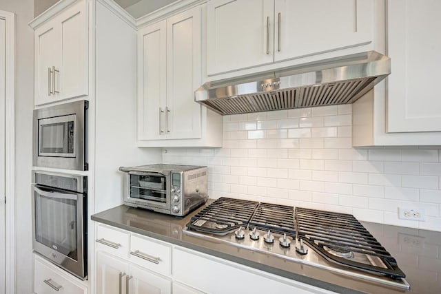 600 E Baylee Love Ln, Austin, TX 78717 - kitchen featuring custom range hood, stainless steel appliances, white cabinetry, and backsplash
