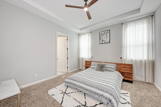 600 E Baylee Love Ln, Austin, TX 78717 - carpeted bedroom with a tray ceiling and a ceiling fan
