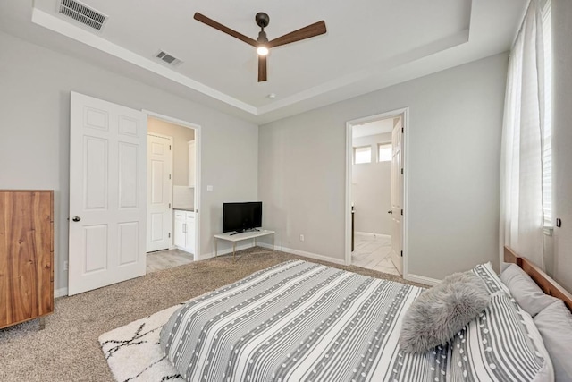 600 E Baylee Love Ln, Austin, TX 78717 - bedroom with a tray ceiling, light colored carpet, and ensuite bath