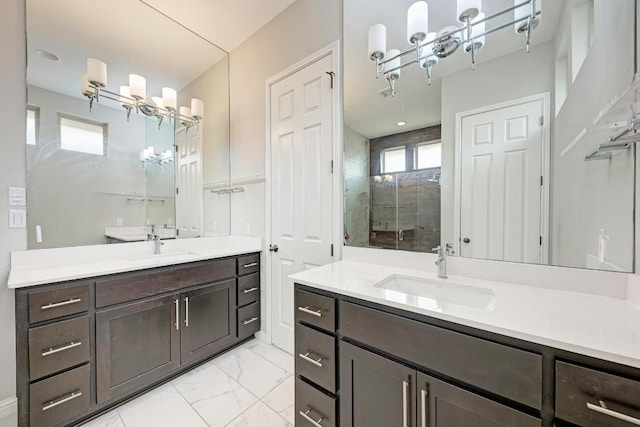 600 E Baylee Love Ln, Austin, TX 78717 - bathroom with a chandelier, two vanities, a shower stall, and marble finish flooring