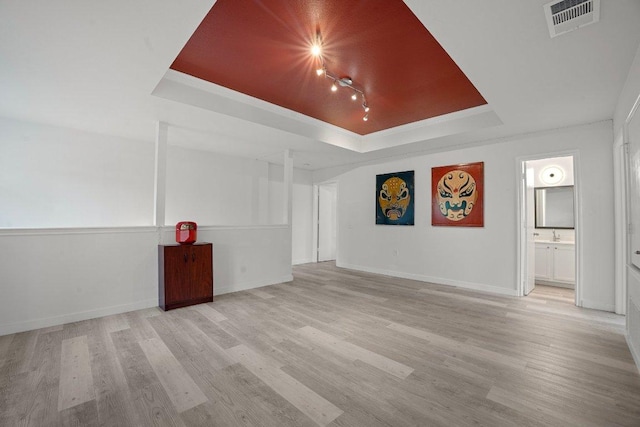 7625 Cayenne Ln, Austin, TX 78741 - empty room featuring a raised ceiling and wood finished floors