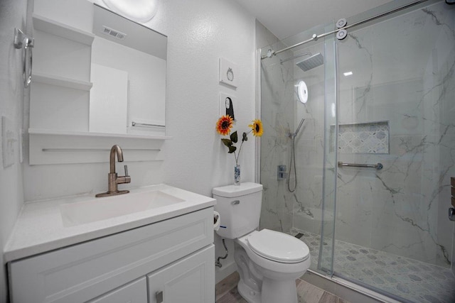 7625 Cayenne Ln, Austin, TX 78741 - bathroom featuring vanity, a marble finish shower, and wood finished floors