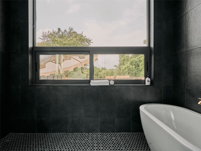 412 Kemp St, Austin, TX 78741 - full bathroom featuring a freestanding tub, tile walls, and tile patterned flooring