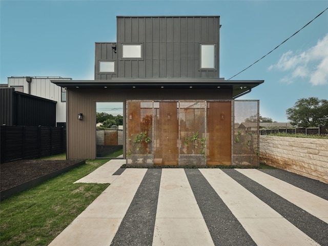 412 Kemp St, Austin, TX 78741 - rear view of house with board and batten siding and a patio area